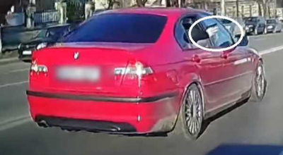 (VIDEO) A fost filmat cum flutura cu arma pe geamul unui BMW. Află ce explicații le-a dat polițiștilor - Photo