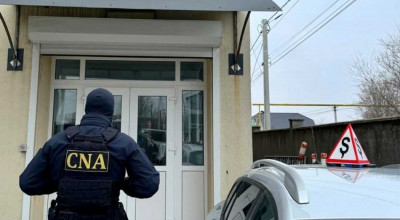 CNA a efectuat mai multe percheziții într-un dosar de eliberare a permiselor de conducere - Photo